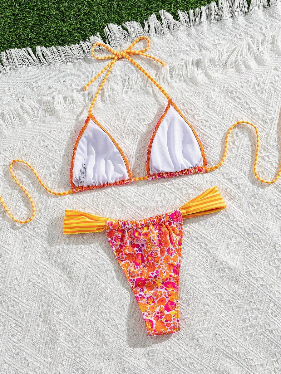 Women's striped halter two-piece swimsuit featuring a lace-up triangle top with removable padding and high-cut low-waist bikini bottoms.