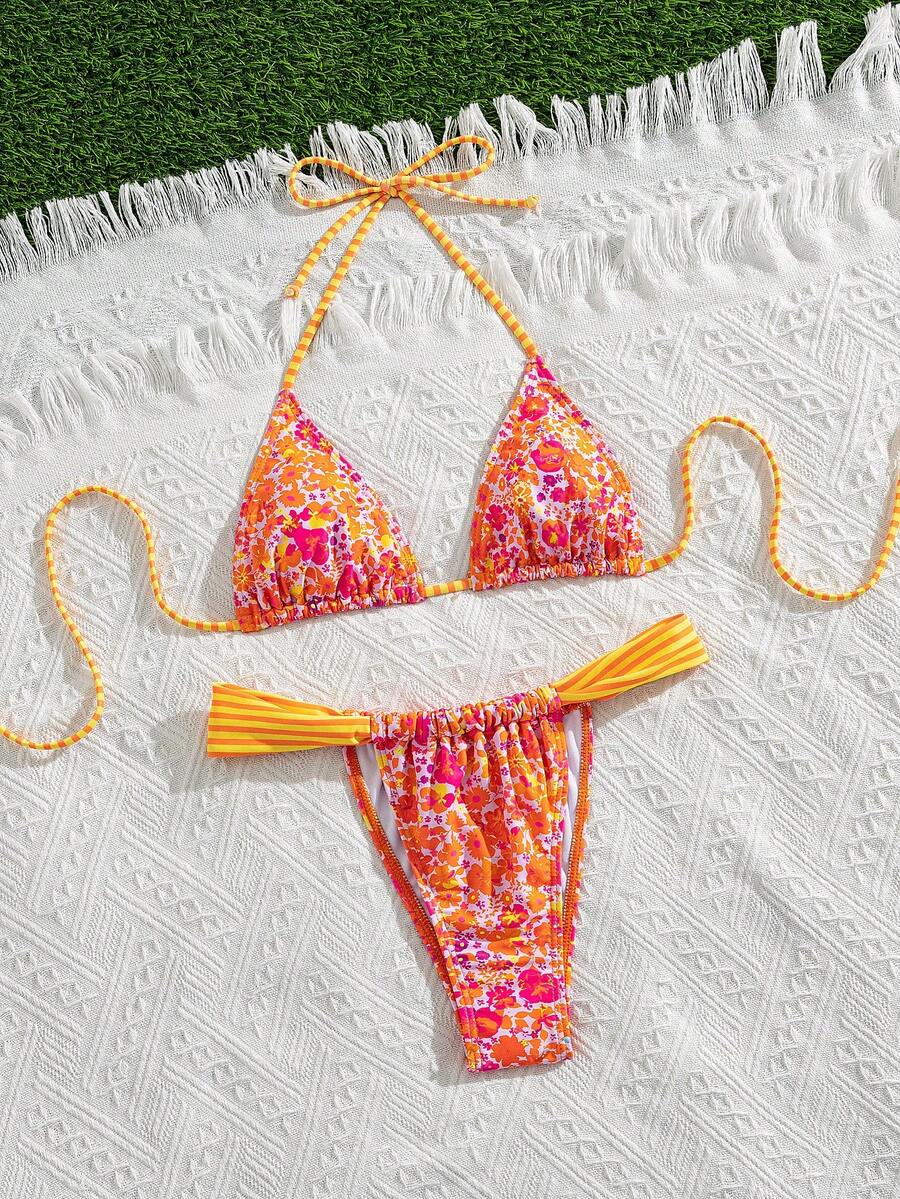 Women's striped halter two-piece swimsuit featuring a lace-up triangle top with removable padding and high-cut low-waist bikini bottoms.