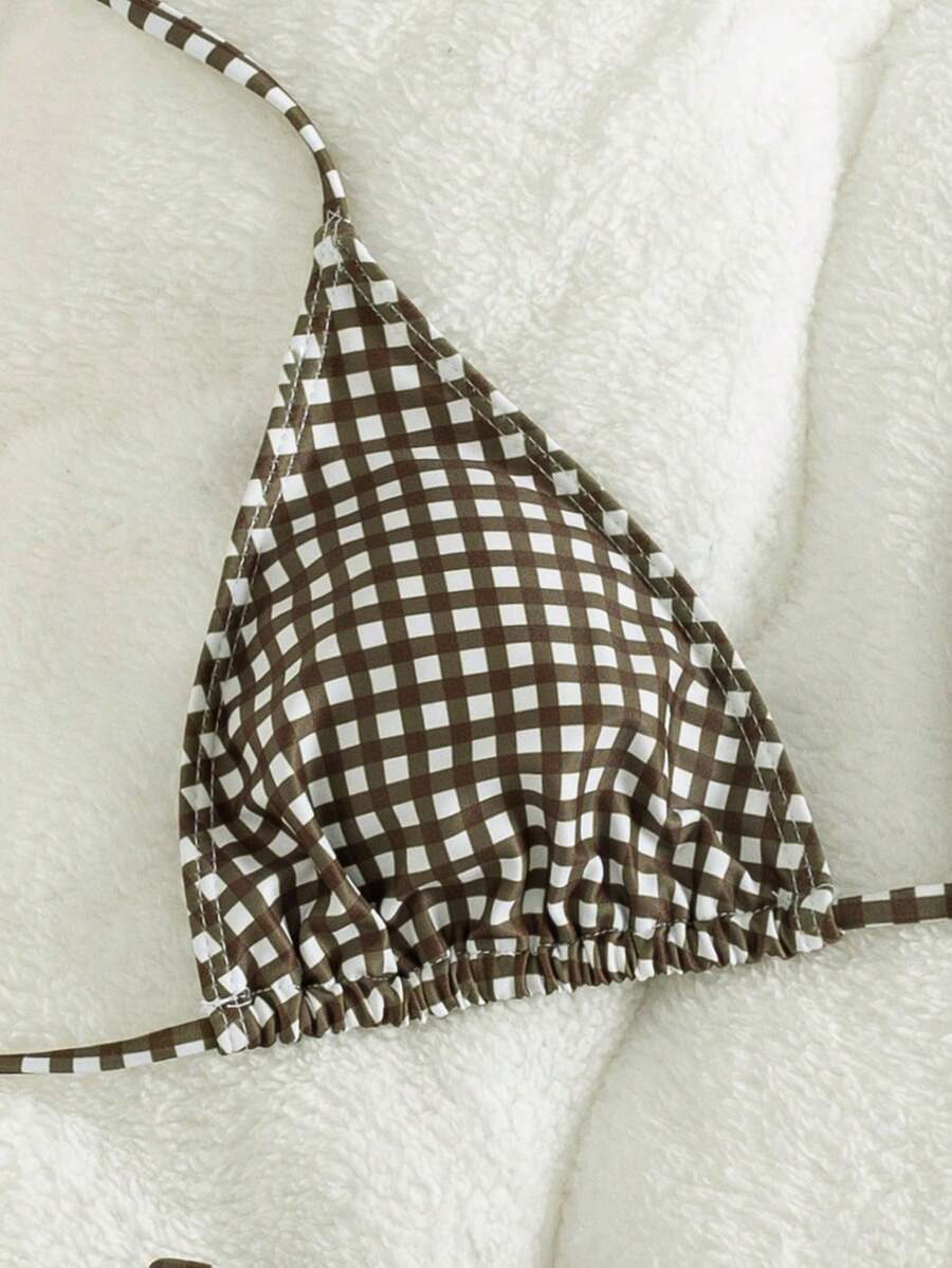 Women's striped halter two-piece swimsuit featuring a lace-up triangle top with removable padding and high-cut low-waist bikini bottoms.