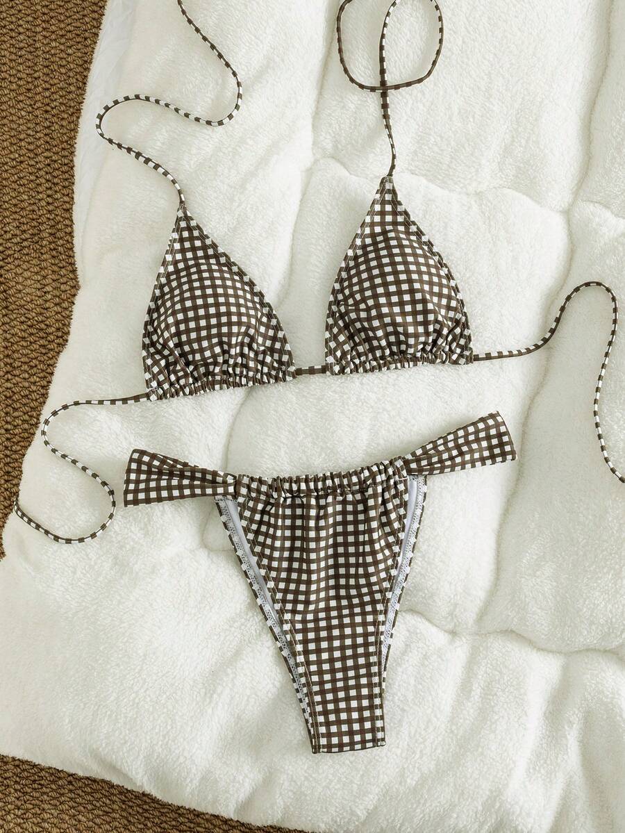 Women's striped halter two-piece swimsuit featuring a lace-up triangle top with removable padding and high-cut low-waist bikini bottoms.