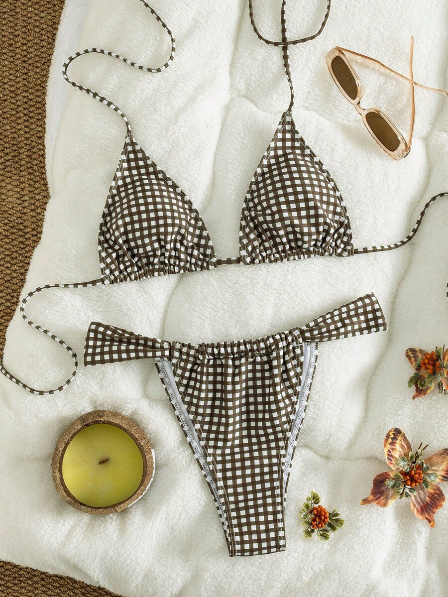 Women's striped halter two-piece swimsuit featuring a lace-up triangle top with removable padding and high-cut low-waist bikini bottoms.