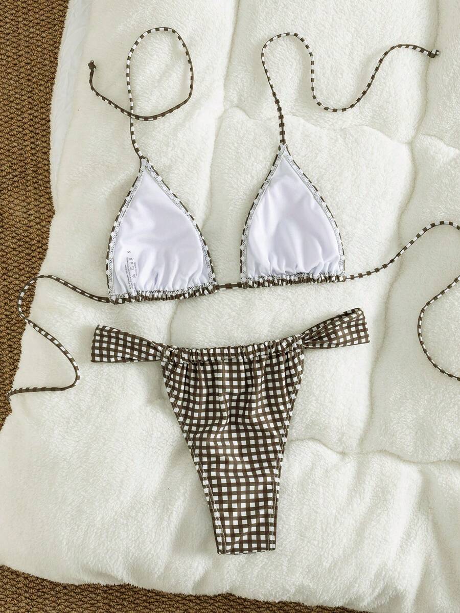 Women's striped halter two-piece swimsuit featuring a lace-up triangle top with removable padding and high-cut low-waist bikini bottoms.