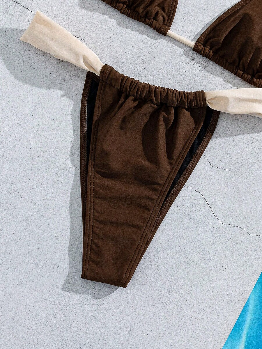 Women's striped halter two-piece swimsuit featuring a lace-up triangle top with removable padding and high-cut low-waist bikini bottoms.
