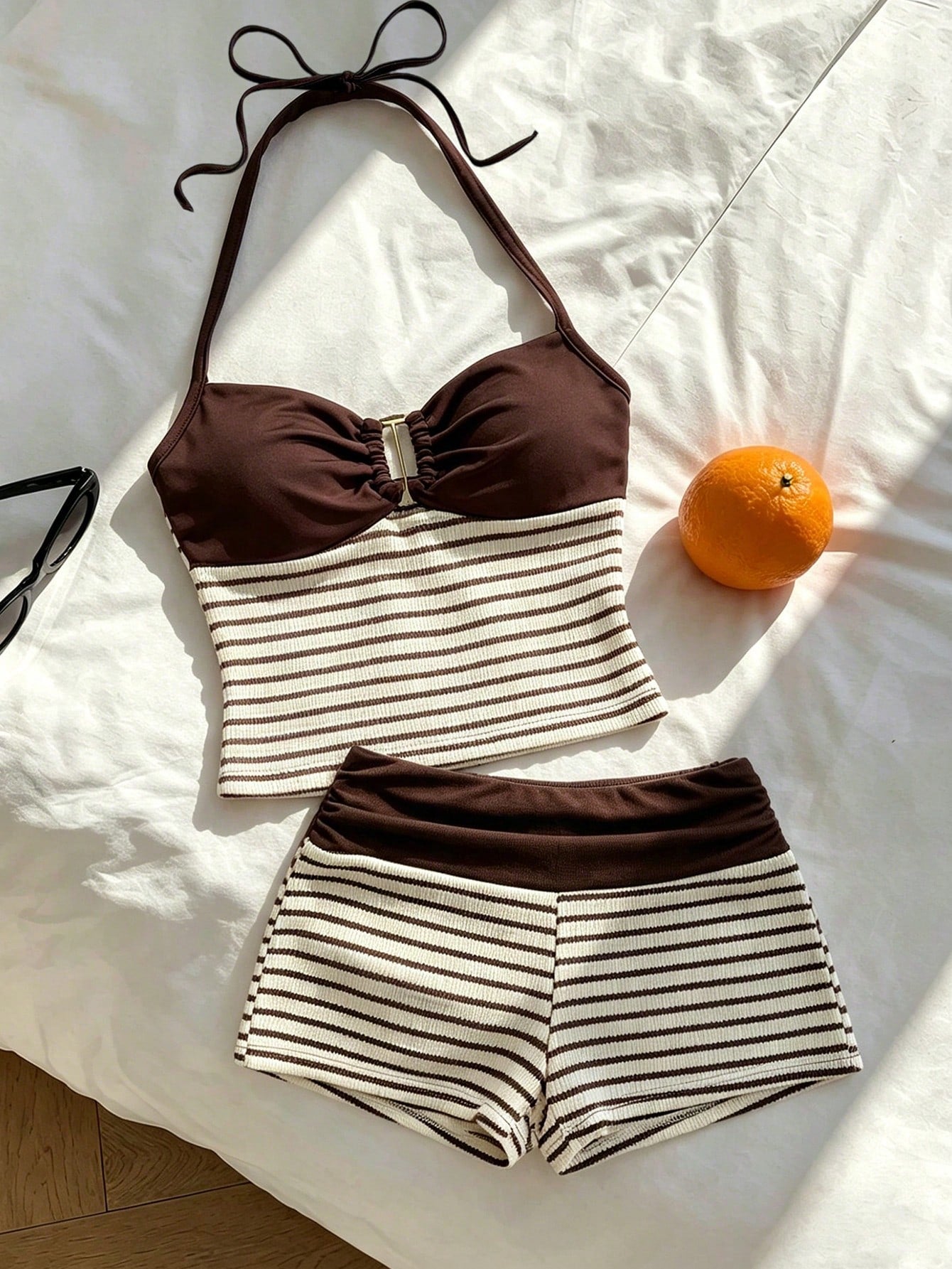 Tween girls black and white striped two-piece set featuring a spaghetti strap micro crop tank top with lettuce trim and ruffle hem paired with matching slim fit shorts.