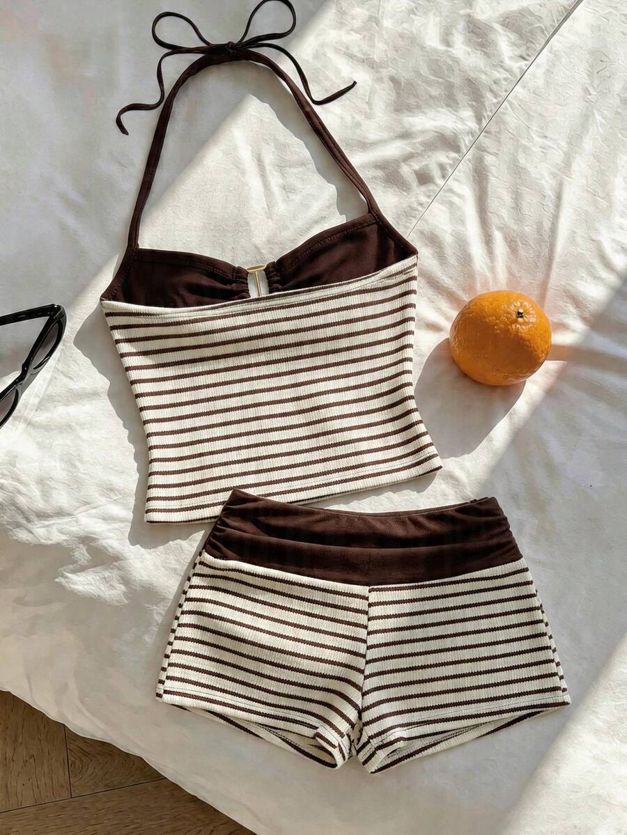 Tween girls black and white striped two-piece set featuring a spaghetti strap micro crop tank top with lettuce trim and ruffle hem paired with matching slim fit shorts.