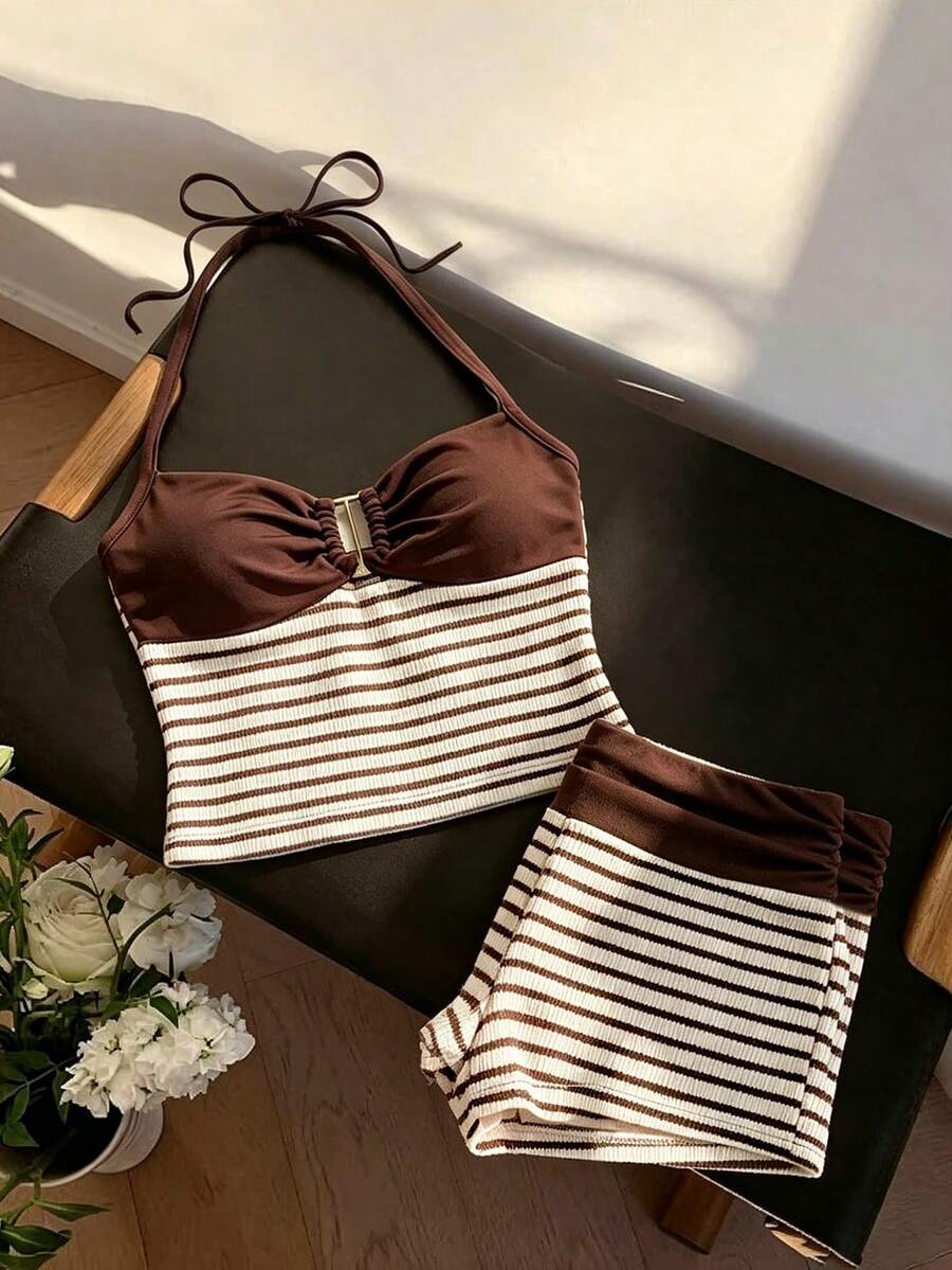 Tween girls black and white striped two-piece set featuring a spaghetti strap micro crop tank top with lettuce trim and ruffle hem paired with matching slim fit shorts.