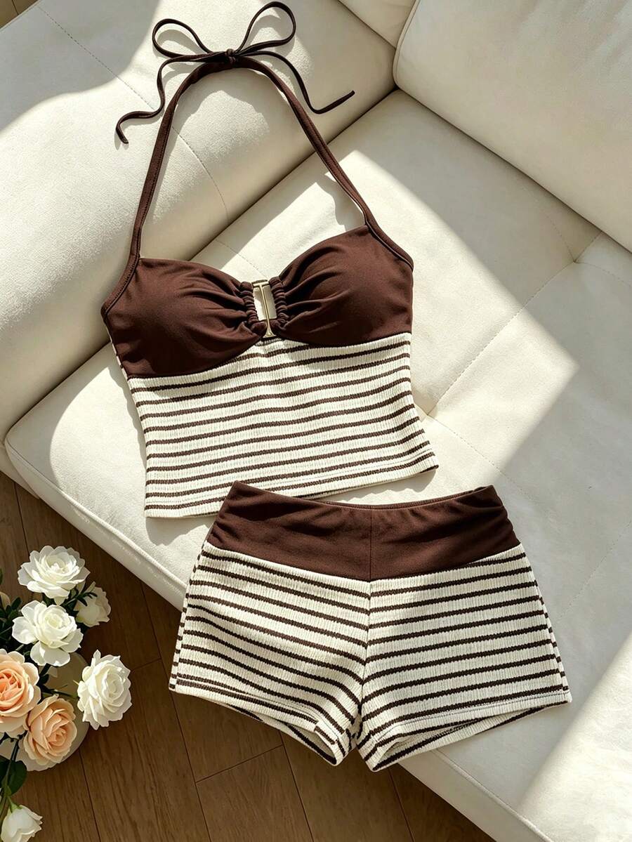 Tween girls black and white striped two-piece set featuring a spaghetti strap micro crop tank top with lettuce trim and ruffle hem paired with matching slim fit shorts.