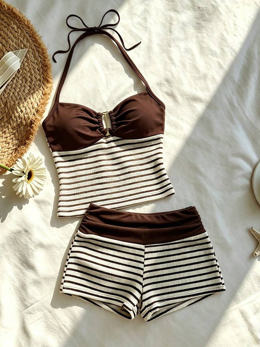 Tween girls black and white striped two-piece set featuring a spaghetti strap micro crop tank top with lettuce trim and ruffle hem paired with matching slim fit shorts.