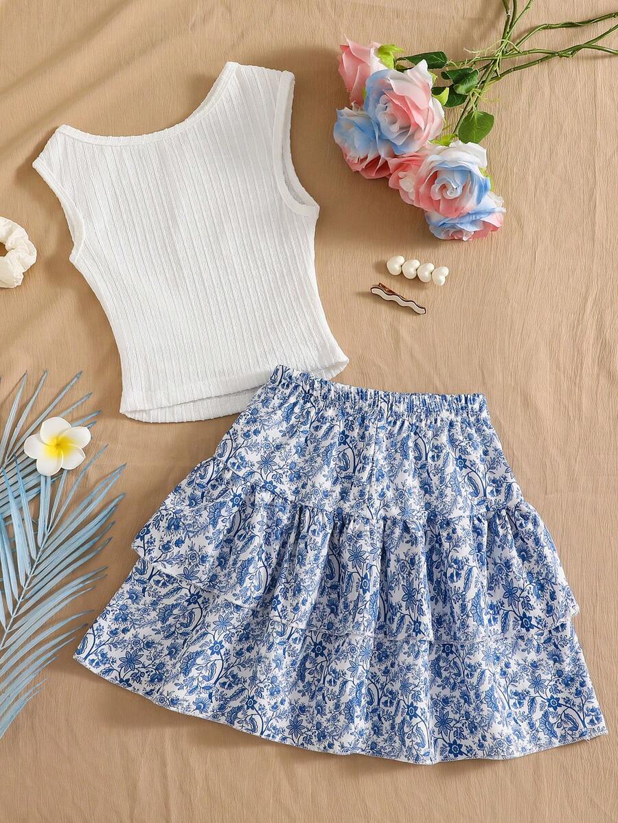 Light blue two-piece outfit set for tween girls with a sleeveless round neck vest top and a tiered ruffle cake skirt featuring a plant pattern.