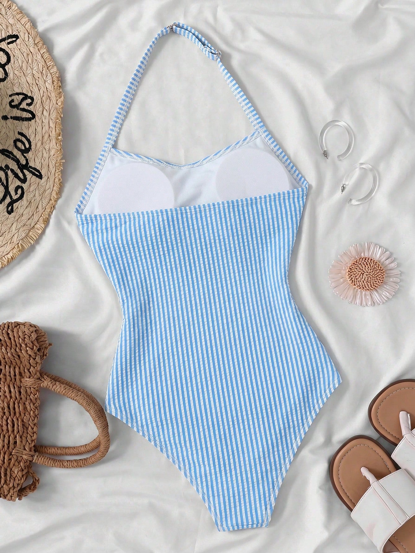 Tween girls one-piece swimsuit with polka dot-inspired all-over print, bow detail, spaghetti strap halter neckline, and lined stretch fabric for beach or vacation wear