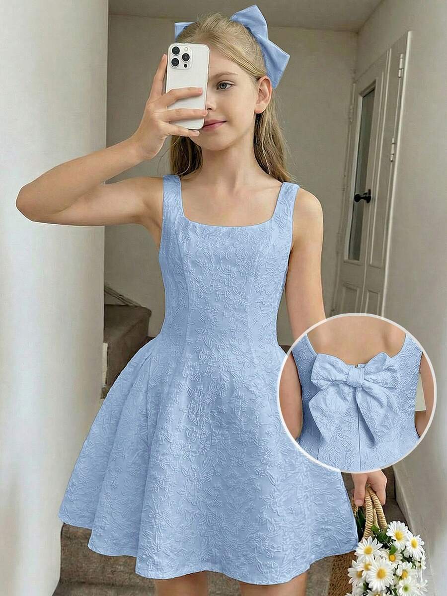 Black and white polka dot cami dress for tween girls featuring a square neckline, high waist, and flared short A-line hem.
