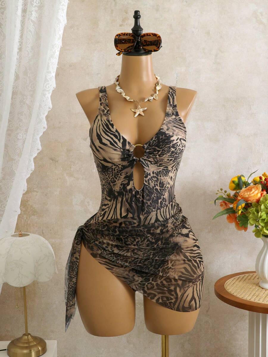Women's black floral print plunge neck one-piece swimsuit featuring cut-out detail paired with a matching knee-length mesh cover-up skirt