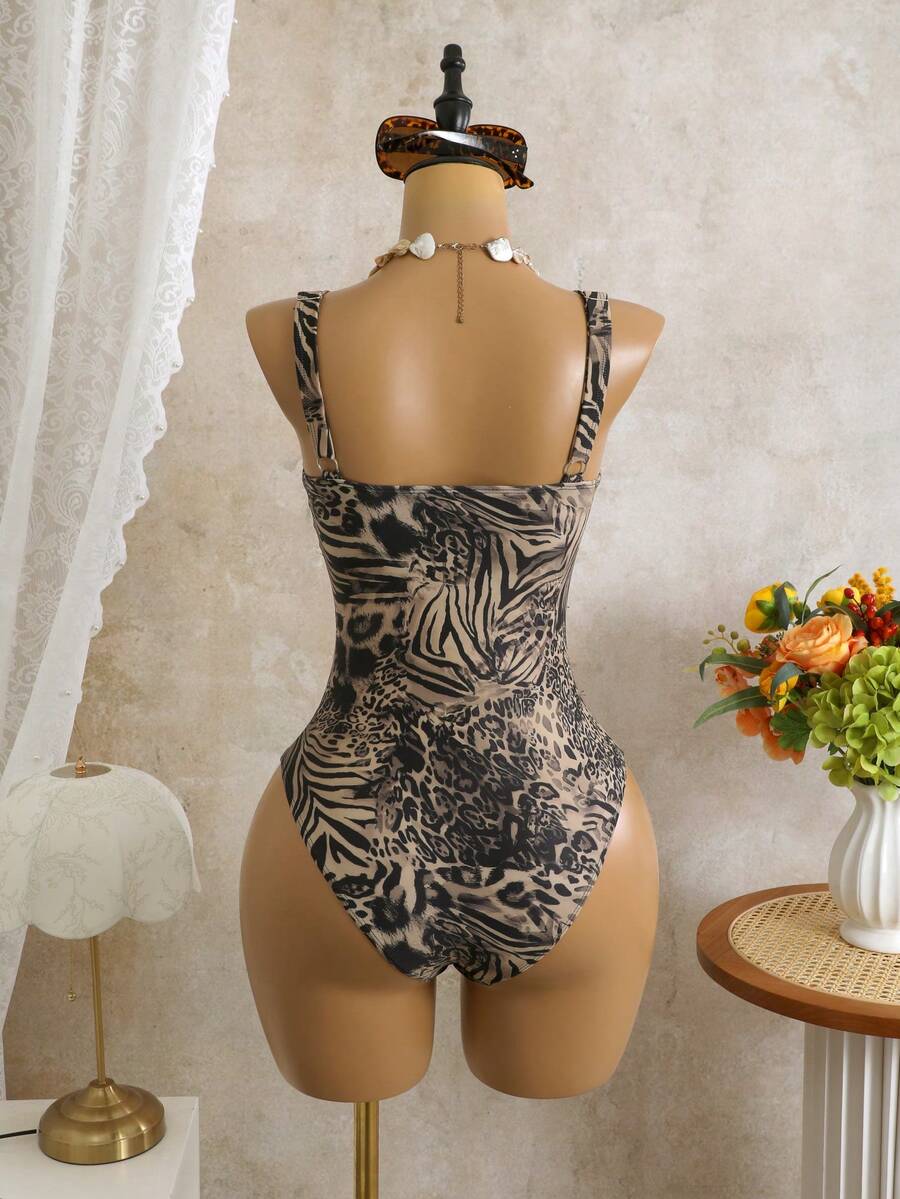 Women's black floral print plunge neck one-piece swimsuit featuring cut-out detail paired with a matching knee-length mesh cover-up skirt