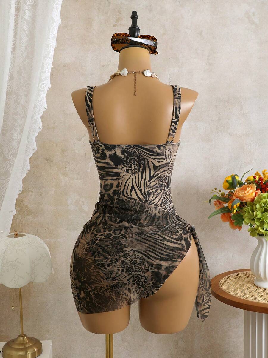 Women's black floral print plunge neck one-piece swimsuit featuring cut-out detail paired with a matching knee-length mesh cover-up skirt