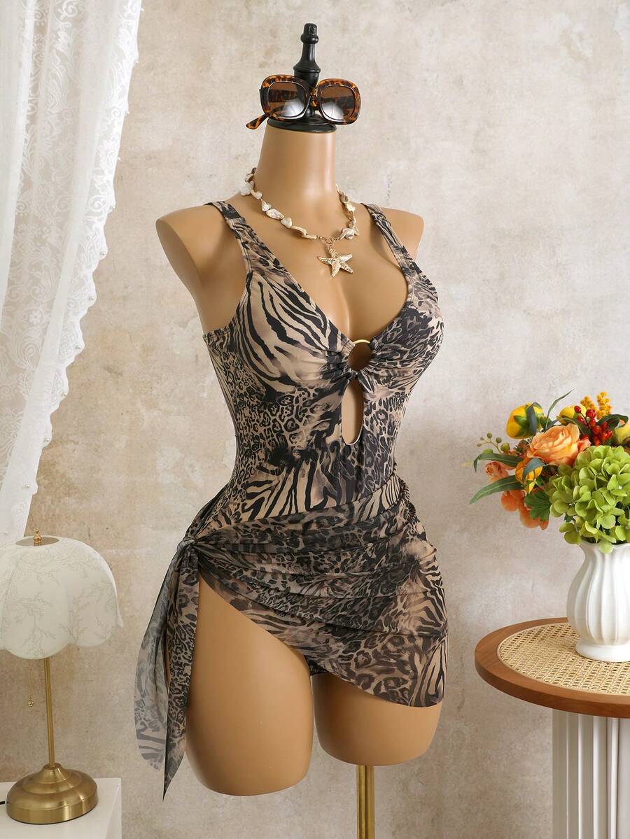 Women's black floral print plunge neck one-piece swimsuit featuring cut-out detail paired with a matching knee-length mesh cover-up skirt