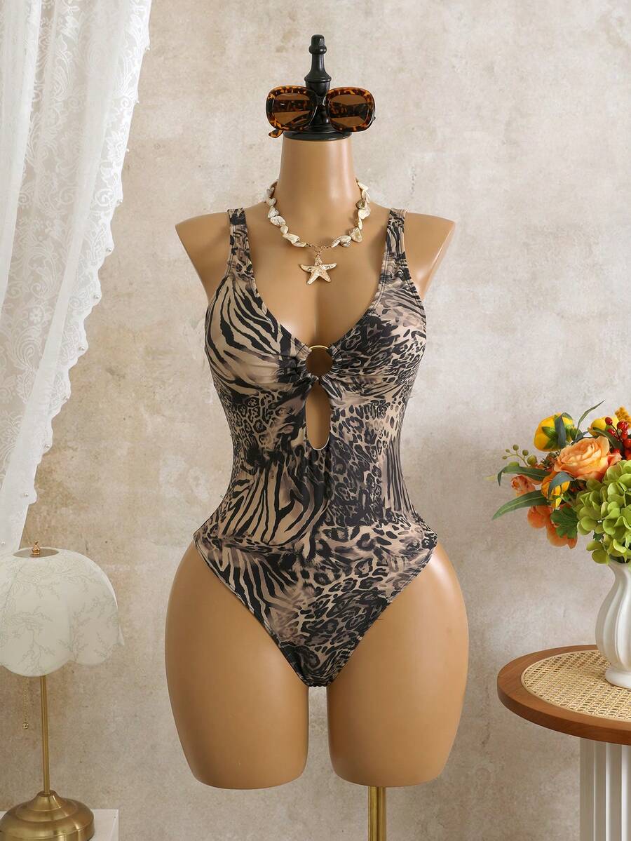 Women's black floral print plunge neck one-piece swimsuit featuring cut-out detail paired with a matching knee-length mesh cover-up skirt