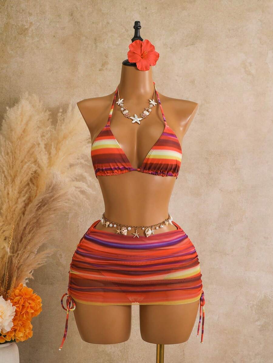 Women's black 3-piece bikini set featuring a halter triangle top with removable padding, high-waisted bottoms, and a knee-length mesh skirt with tie details.