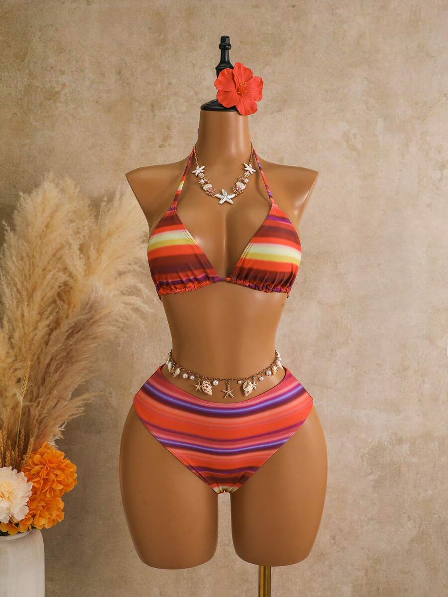 Women's black 3-piece bikini set featuring a halter triangle top with removable padding, high-waisted bottoms, and a knee-length mesh skirt with tie details.