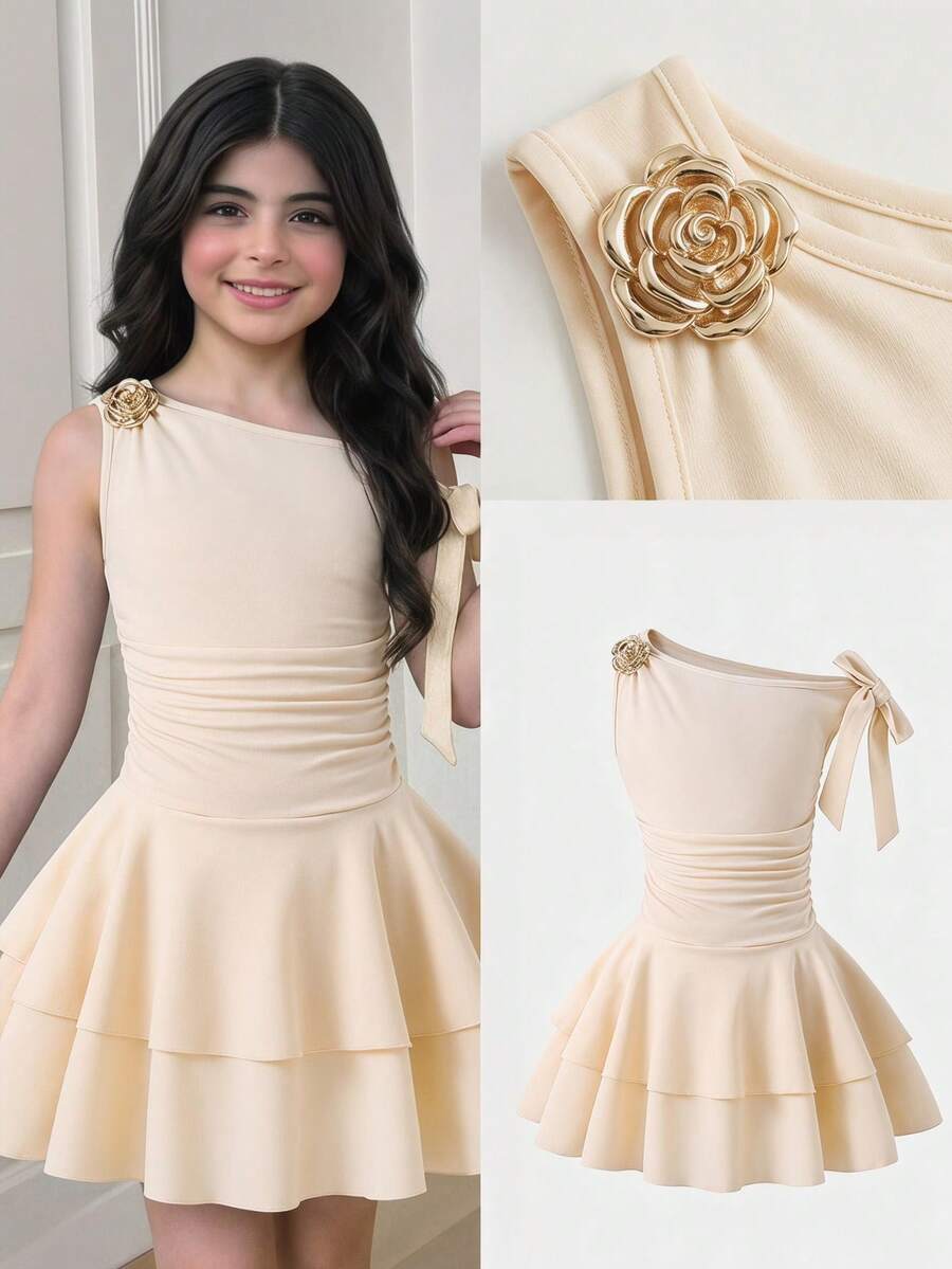 Tween girl wearing an apricot asymmetric skater dress with ruffle and applique details for party and formal occasions.