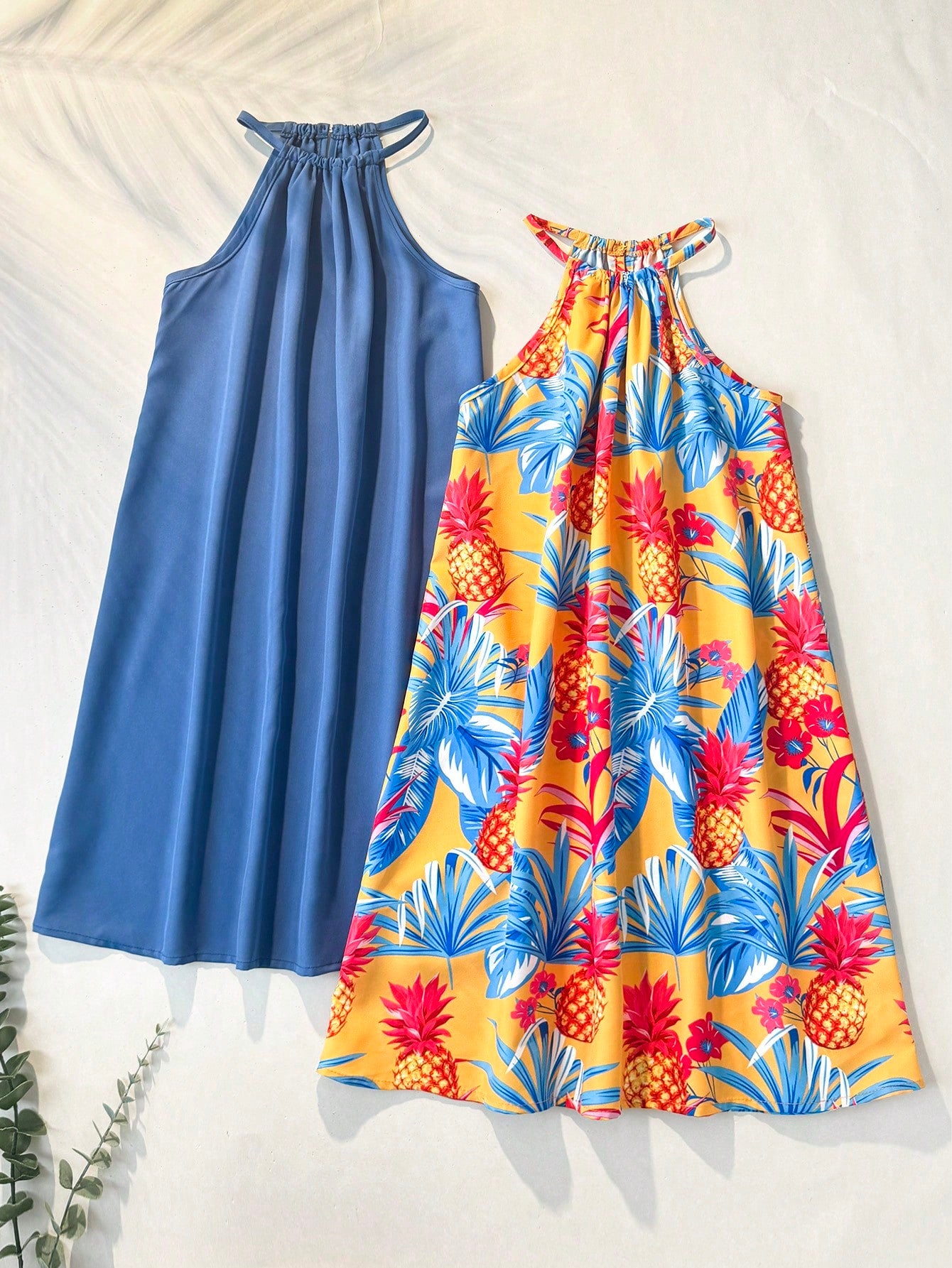 Tween girls floral print dress with halter neckline, sleeveless cold shoulder design, A-line shape, and vacation style.