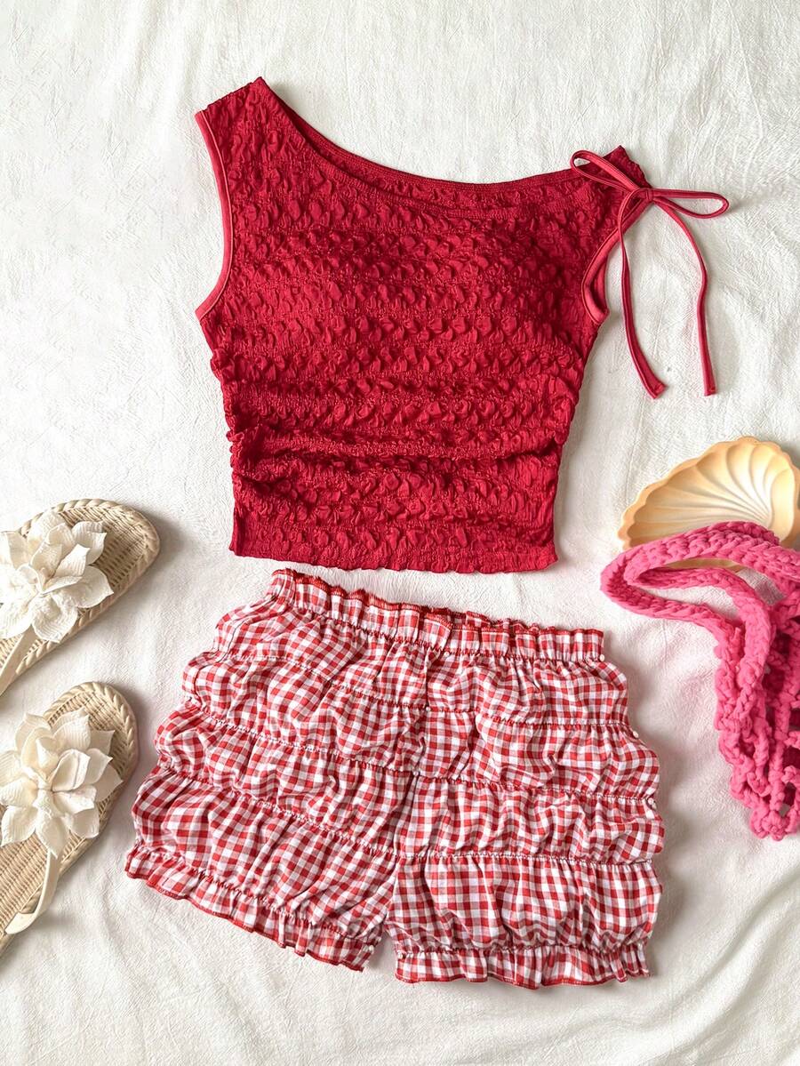 Tween girl wearing a casual 2-piece set featuring a black rib-knit scoop neck tank top and leopard print paperbag waist shorts with a matching belt.