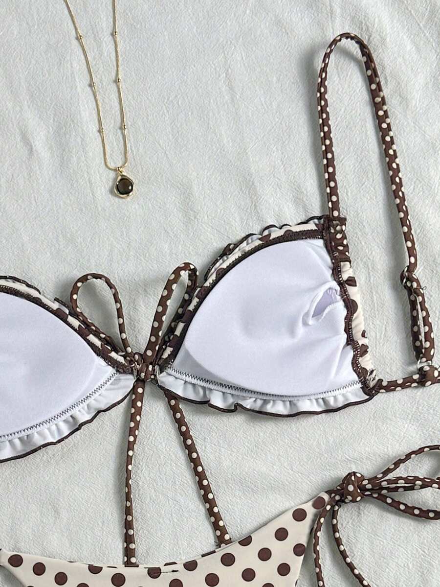 Women's beige two-piece bikini set featuring a wireless top with removable padding, spaghetti straps, tie back detail, and low waist hipster swimsuit bottoms.
