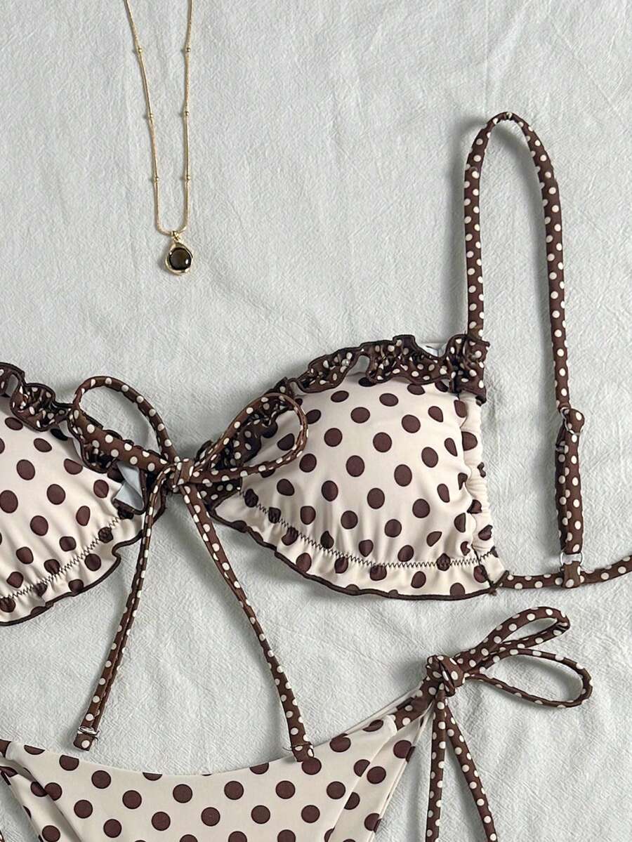 Women's beige two-piece bikini set featuring a wireless top with removable padding, spaghetti straps, tie back detail, and low waist hipster swimsuit bottoms.
