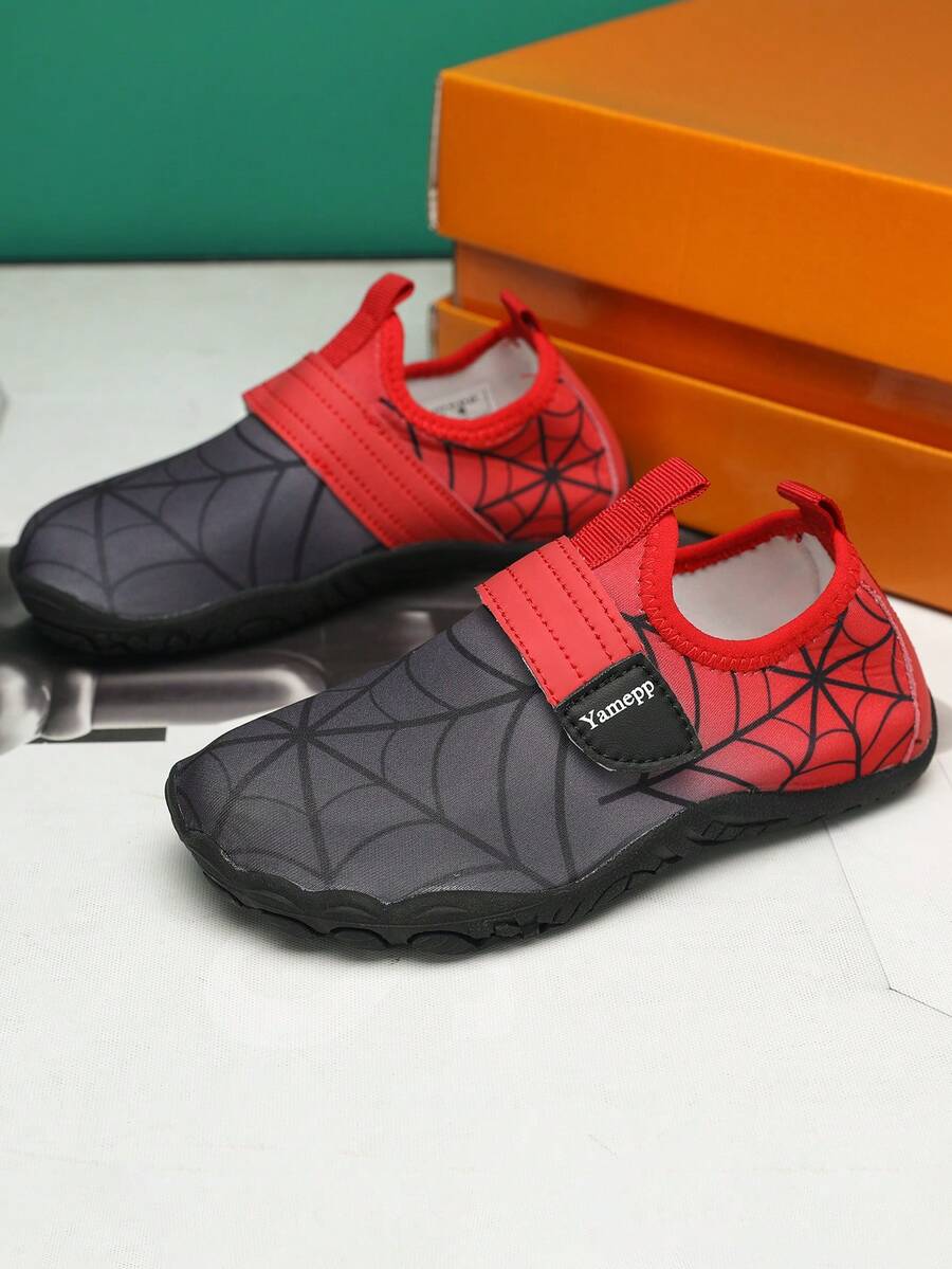 Black kids water shoes featuring a spider web graphic design, fabric upper, hook loop closure, and non-slip rubber outsole.