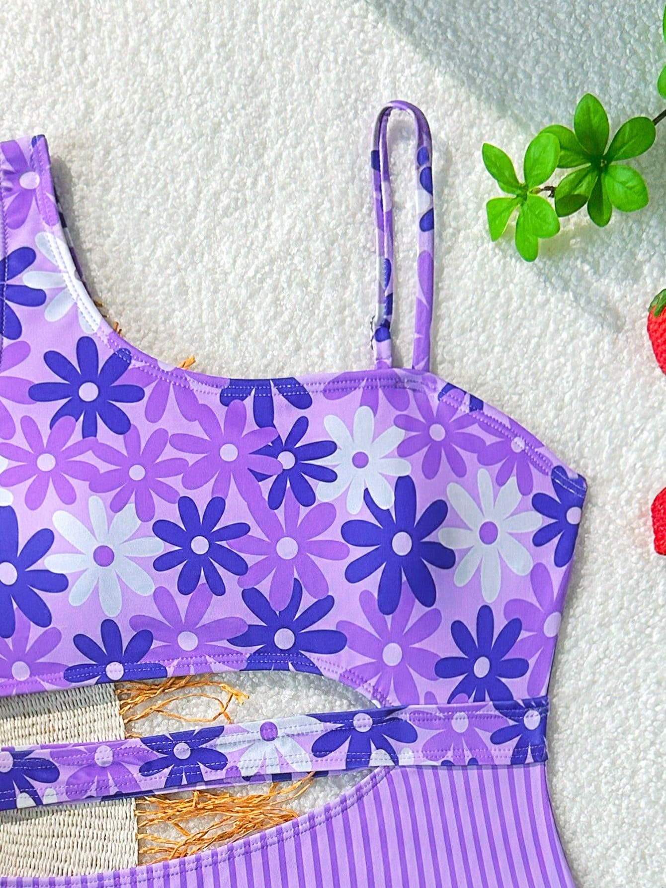 Purple tween girls one-piece swimsuit with asymmetrical neckline, cut-out waist, striped pattern, fitted silhouette, and lined body.