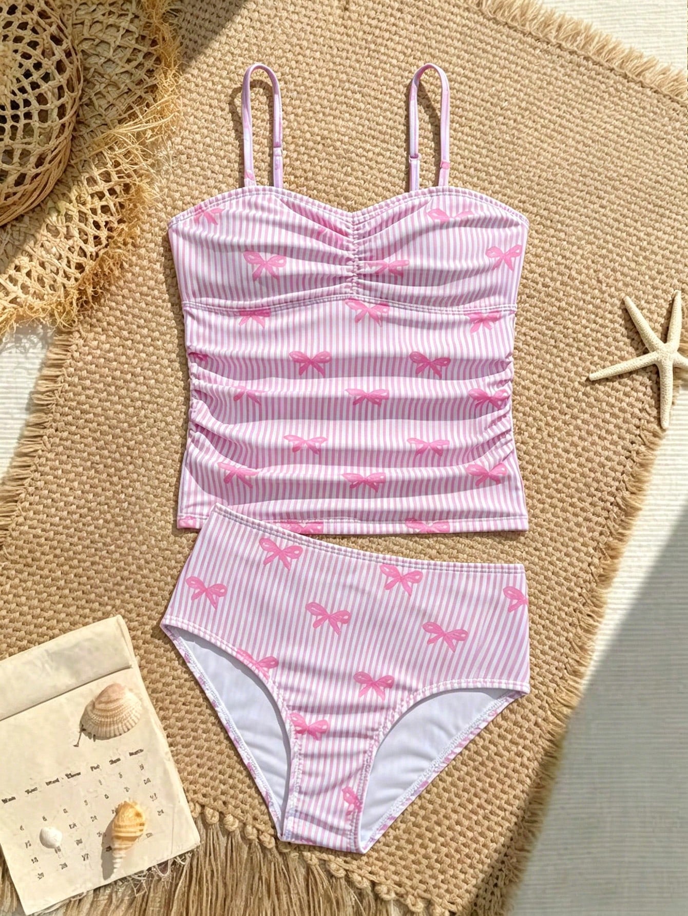 Tween girls 2-piece bikini swimwear set in black with a wave-pattern geometric design, featuring halter neckline, wireless top, and high-waist short bottoms with starfish and shell decor.
