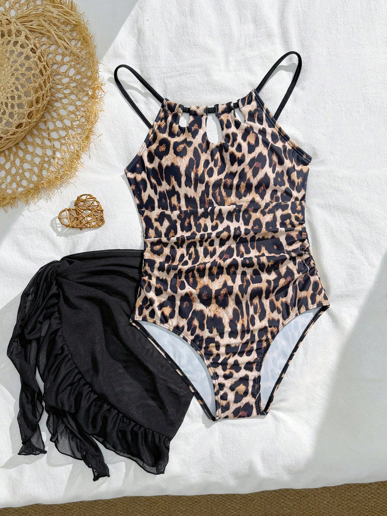 Girls black and white one-piece swimsuit set with cut-out detail, spaghetti straps, sleeveless fitted design, and matching skirt bottom for vacation swimwear.