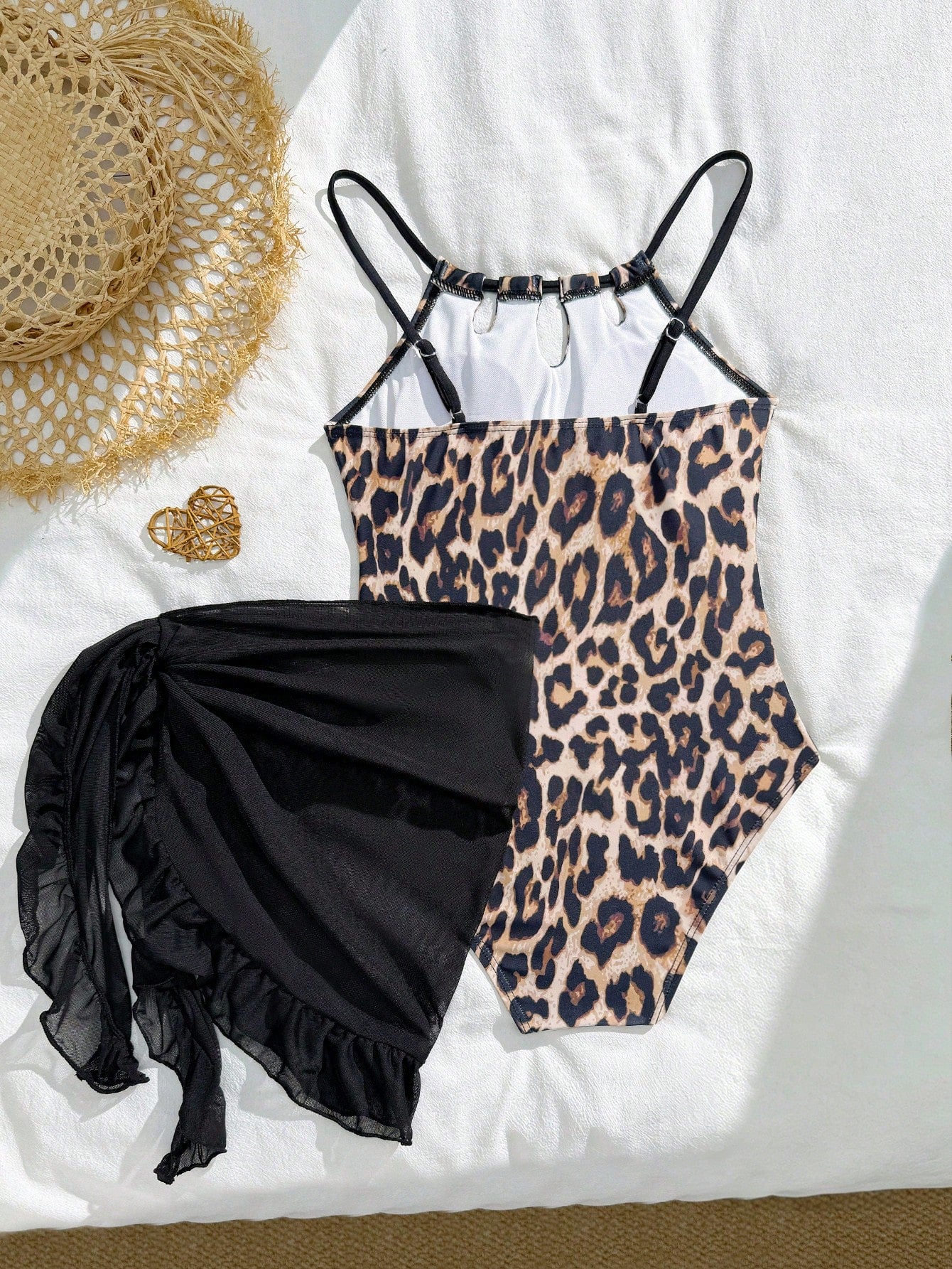 Girls black and white one-piece swimsuit set with cut-out detail, spaghetti straps, sleeveless fitted design, and matching skirt bottom for vacation swimwear.