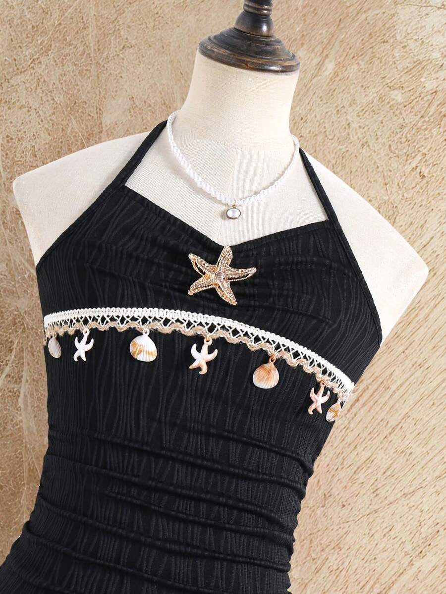 Tween girls apricot sleeveless halter mini dress with textured starfish and shell decor, shirred tiered layer, high waist, and flounce hem.
