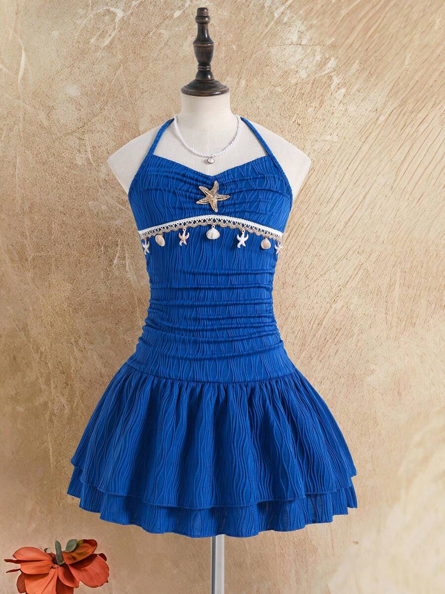 Tween girls apricot sleeveless halter mini dress with textured starfish and shell decor, shirred tiered layer, high waist, and flounce hem.