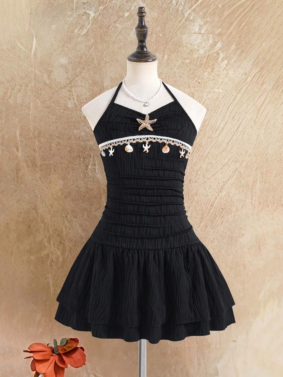 Tween girls apricot sleeveless halter mini dress with textured starfish and shell decor, shirred tiered layer, high waist, and flounce hem.