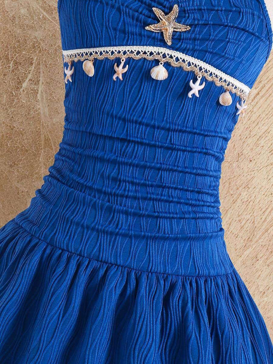 Tween girls apricot sleeveless halter mini dress with textured starfish and shell decor, shirred tiered layer, high waist, and flounce hem.