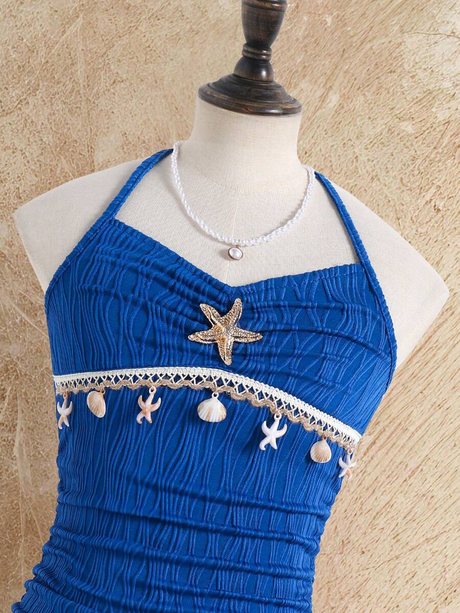 Tween girls apricot sleeveless halter mini dress with textured starfish and shell decor, shirred tiered layer, high waist, and flounce hem.