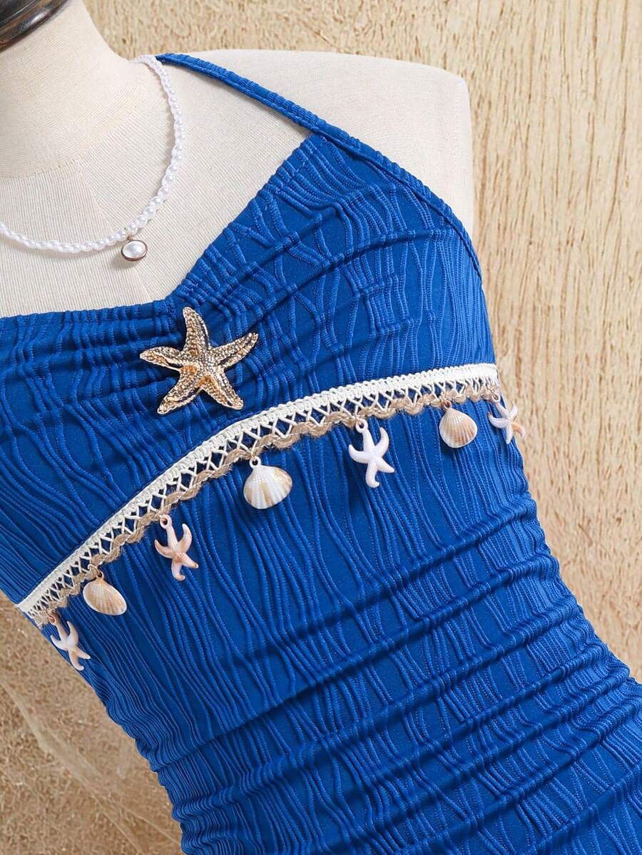 Tween girls apricot sleeveless halter mini dress with textured starfish and shell decor, shirred tiered layer, high waist, and flounce hem.