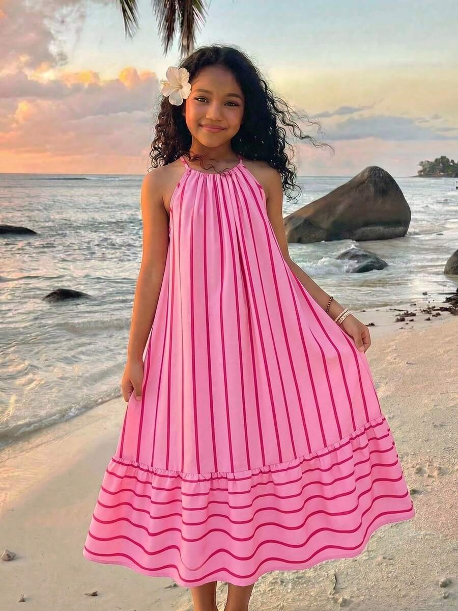 Tween girls green floral print cami dress with halter neckline, sleeveless cut, zipper detail, flared hem, and long vacation style silhouette.