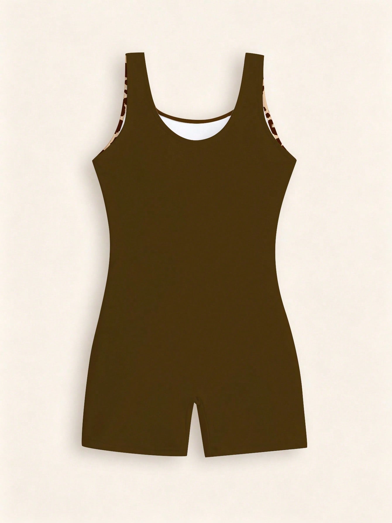 Tween girls one-piece swimsuit with scoop neck, contrast piping, short length, and shorts bottom for summer beach and vacation wear