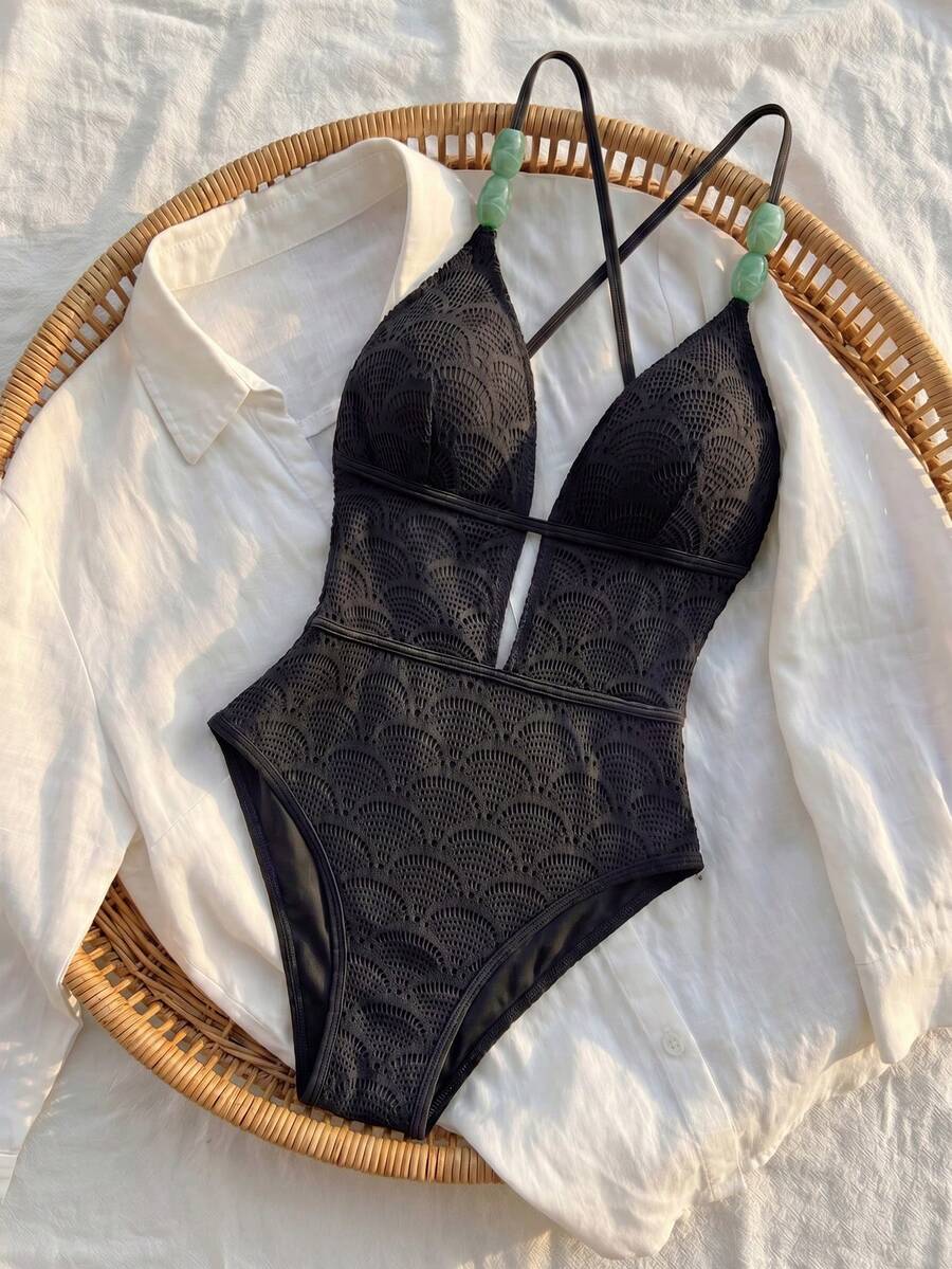 Women's fresh green boho one-piece swimsuit featuring a lace-up V-neckline, textured stretch fabric, and sleeveless design for beach and vacation wear.