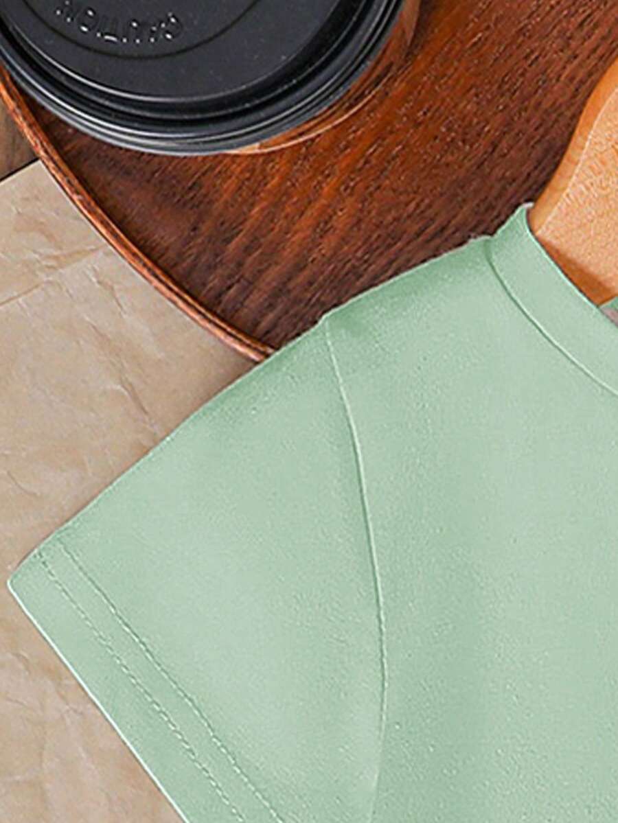 Tween girls two-piece green summer outfit featuring a fruit print short sleeve round neck t-shirt and matching track shorts with pockets.