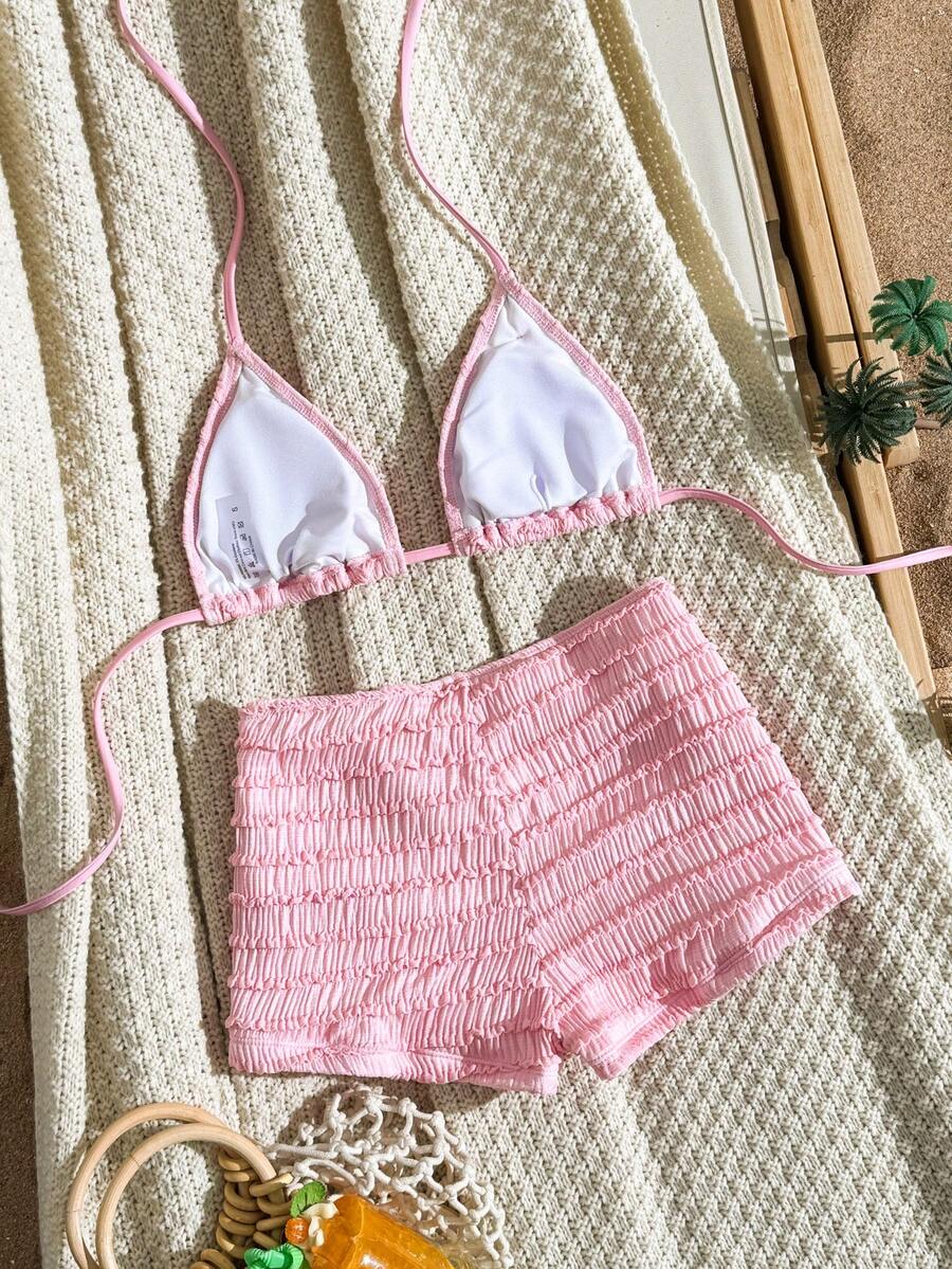 Women's apricot two-piece swimsuit set with a halter tie-back top and matching high stretch shorts.