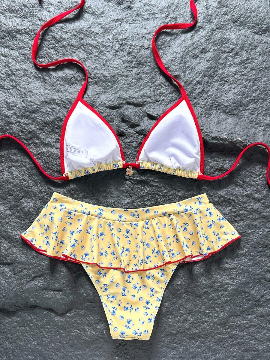 Women's 70s retro black and white polka dot bikini set featuring a halter triangle top and ultra low waist bottoms.
