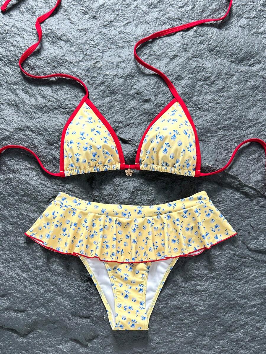 Women's 70s retro black and white polka dot bikini set featuring a halter triangle top and ultra low waist bottoms.