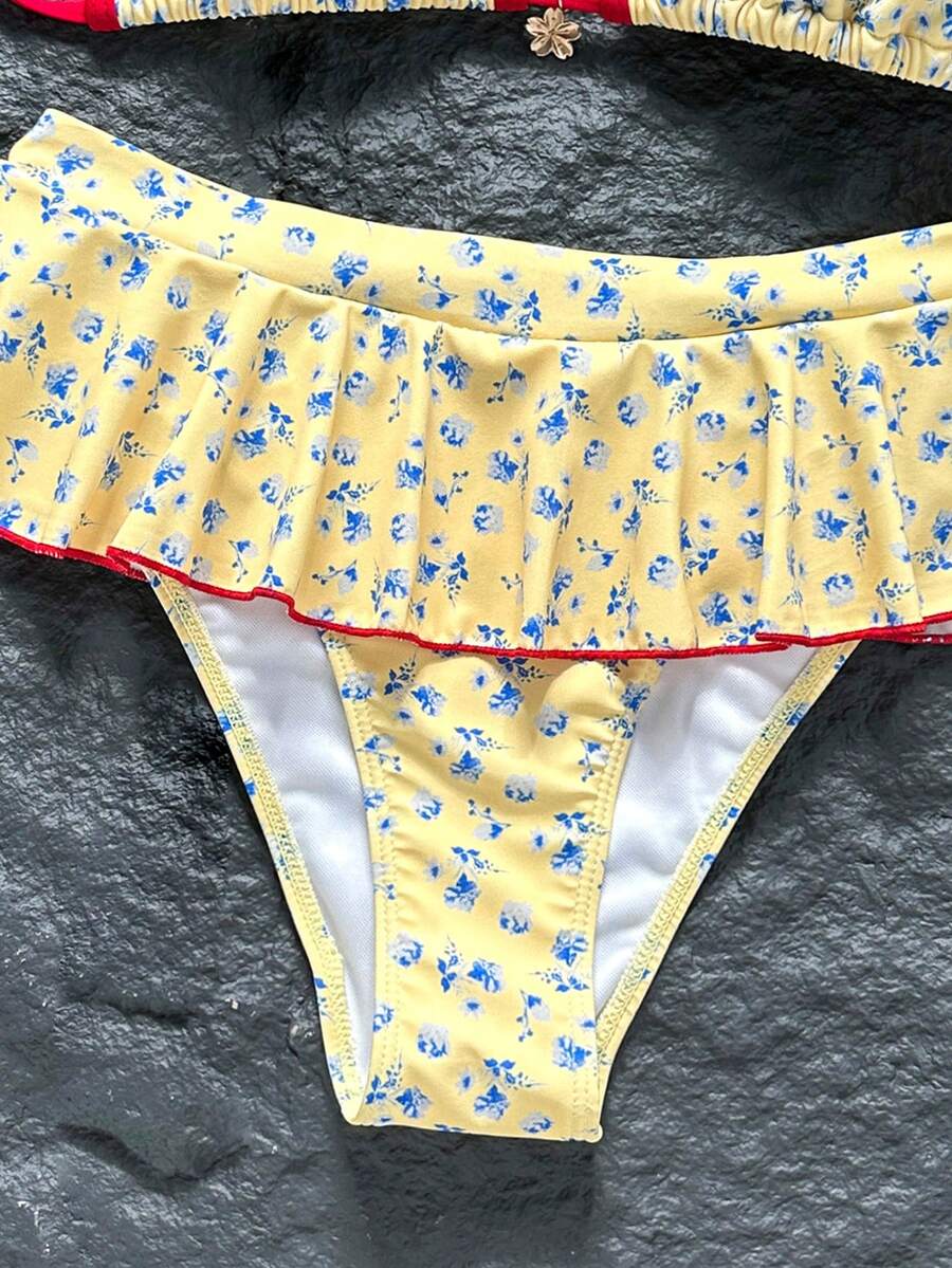 Women's 70s retro black and white polka dot bikini set featuring a halter triangle top and ultra low waist bottoms.