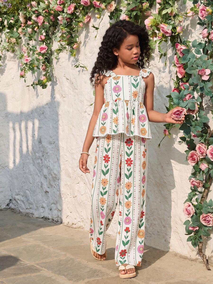 Tween girl wearing an apricot 2-piece outfit set featuring a shirred spaghetti strap short cami top and matching wide-leg long pants.