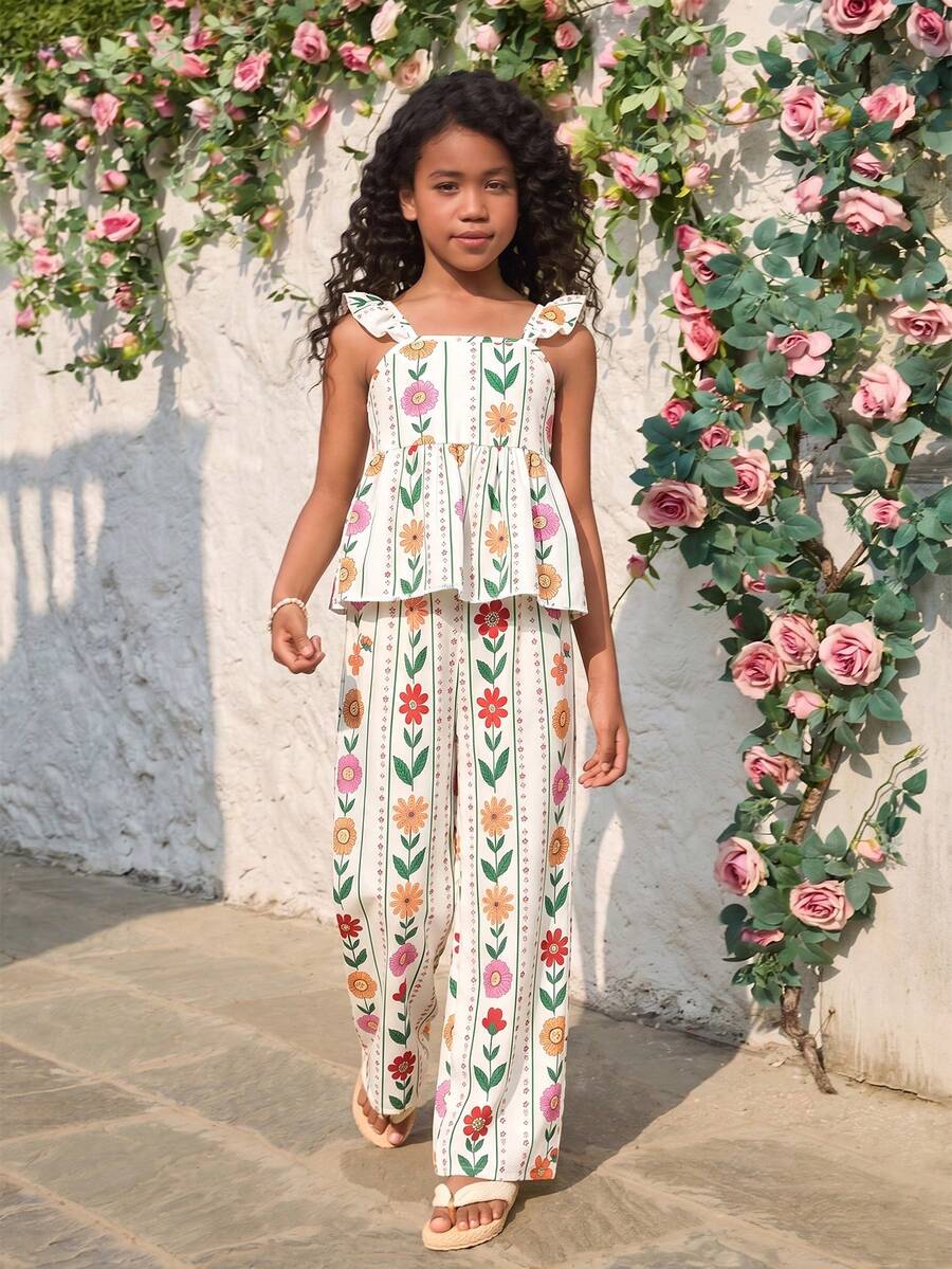 Tween girl wearing an apricot 2-piece outfit set featuring a shirred spaghetti strap short cami top and matching wide-leg long pants.