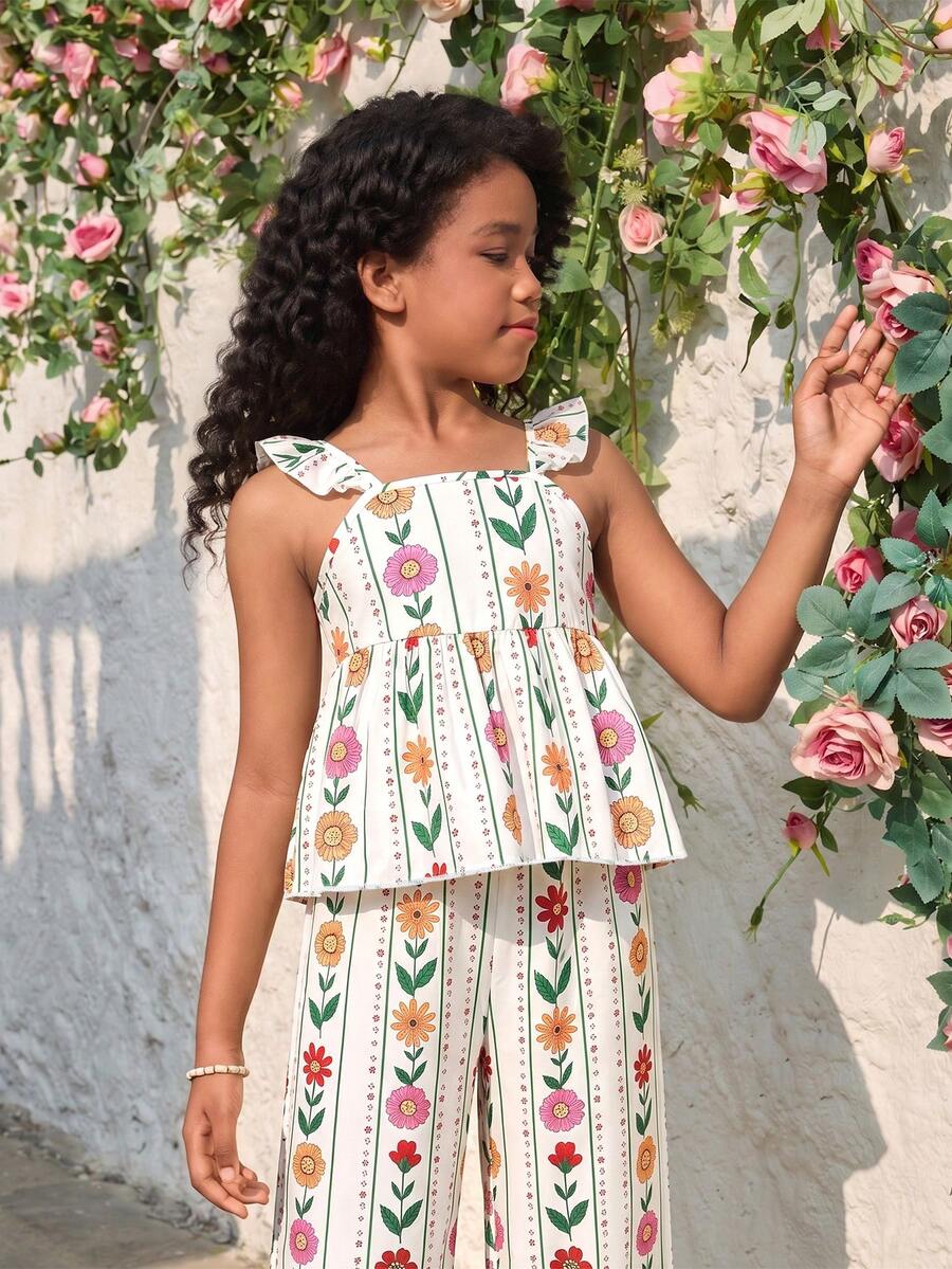 Tween girl wearing an apricot 2-piece outfit set featuring a shirred spaghetti strap short cami top and matching wide-leg long pants.