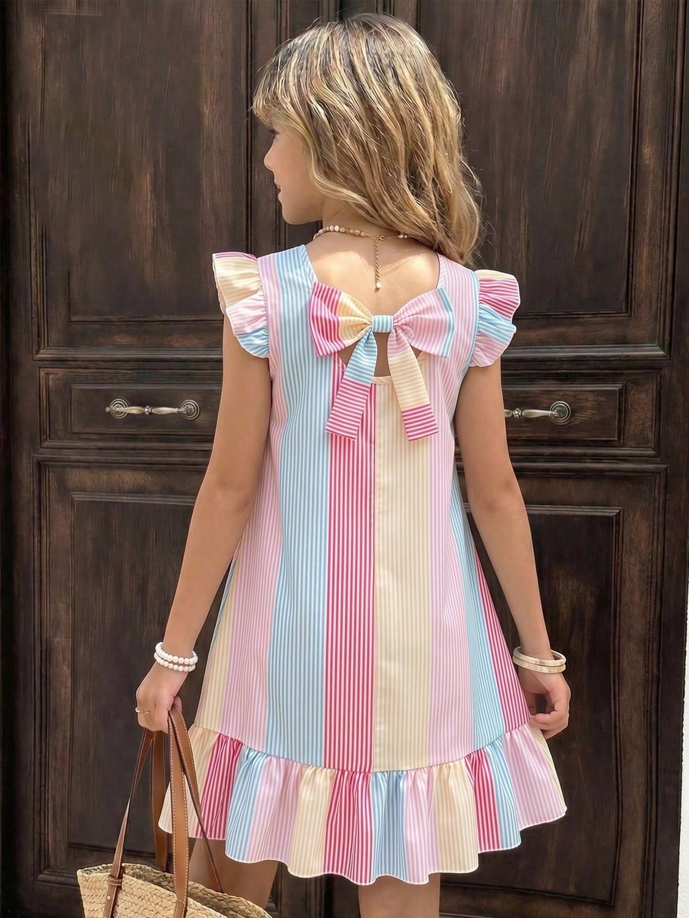 Tween girls apricot vacation midi dress featuring a round neck, cut out details, ruffle flounce accents, and geometric pattern.